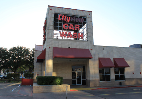 The color photo shows the Cityview Car Wash building in Fort Worth, Texas. The Cityview Car Wash sign is partially burnt out. No people are visible; things seem a little decaying.