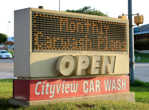 A streetside sign for Cityview Car Wash advertises monthly carwash plans