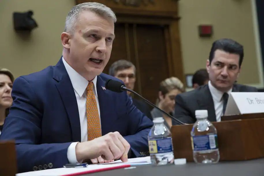 Dr Bright testifying at a Congressional hearing. He looks righteously angry, or at least emphatic.