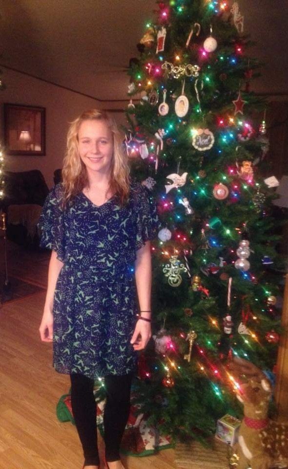 Reality Winner standing next to a Christmas tree at home and smiling